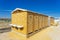 public bathrooms made of recycled wood chipboard for men, women and the disabled.  Sinks for washing hands outside the house