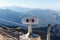 Public binocular telescope on the viewing platform against the background beautiful landscape in the mountains