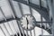 Public clock in railway station at the hanging with roof of subway central train station. It is clock for watch time waiting train