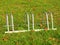 Public empty stand for bikes on grass. Gray iron frame with marks of corrosion.