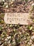 public footpath sign post stone in hedgerow direction pointer