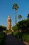 Public garden with palm trees in front of Koutoubia mosque at sunset, Marrakech, Morocco