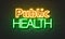 Public health neon sign on brick wall background.