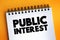 Public Interest - welfare of the general public and society, text concept on notepad