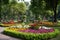 public park with floral arrangement as a centerpiece, attended by visitors