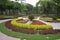 public park with floral arrangement as a centerpiece, attended by visitors