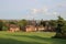 Public park with trees houses and city skyline in background UK