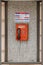 Public pay phone of red color in phone booth in St Petersburg Russia.