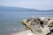 Public pebble beach on the shore of the lake Lago Di Garda, Toscolano Maderno, Italy