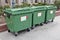 Public plastic green waste garbage containers  of the company Ecoservice on the streets