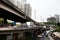 Public and private vehicles wait in line at traffic congested roads and flyovers