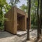 Public restroom with modern design located in a forested area in a natural environment.