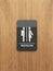 Public restroom sign on the wood