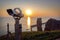 Public telescope at the Lange Anna, the famous sea stack rock of Heligoland with sunset over the north sea, copy space