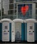Public toilet cabins in the street of Dusseldorf in front of a building with Gemeinsam stark logo