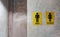 Public toilet of men and women. Sign of lady and gentleman washroom called wc. Mixed gender symbol toilet and restroom behind