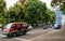 Public transport cars angkot pass on dewi sartika road, Bandung.