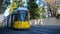 Public transportation concept. Tram yellow, modern, electric at Berlin, Germany. City and nature background