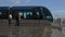 Public transportation, passengers coming out of modern trolley car, cityscape