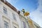 Public utilities on special vehicles remove icicles from the roofs of houses on the Rynok square in Lviv. Roof Winter Workers