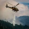 Publish Helicopter battles forest fire with dramatic water drop