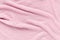 Puckered texture pink crumpled fabric. Abstract background