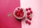 Pudding chia with coconut milk and raspberries on the pink background.