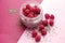 Pudding chia with coconut milk and raspberries on the pink background. Healthy and diet food. Vegan food