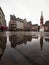 Puddle mirror pond reflection of traditional half-timbered old buildings on Romer square Frankfurt am Main Hesse Germany