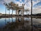 Puddle pond mirror reflection panorama of historic Arc de Triomphe Etoile monument landmark Champs Elysees Paris France