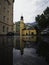 Puddle pond mirror reflection view of yellow Heiliger Antonius church chapel in Lienz East Tyrol Austria alps Europe