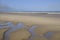 Puddle reflection at beach, netherlands