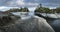 Puddle on a rock in the foreground. Islands and forest. Nordic landscape