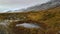 Puddle and snow covered fjord on a cold autumn day