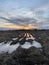 Puddles of water reflecting sunset