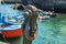 Puerto de la Cruz, Tenerife, Spain - July 10, 2019: Rust anchor in the Old port of town. Small fishing boats of local people.