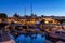 Puerto Del Sol in Cala d\\\'Or, with illuminated sailboats reflected on the water