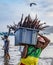 Puerto Lopez, Ecuador - Aug 19, 2016: Man carries bin of fish up the beach from the boat to the waiting processor trucks