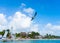 Puerto Morelos seaside view with sea, lighthouse, bird and boats. Caribbean sky with clouds. White sand shore. Background or wallp