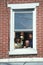 A Puerto Rican family waving from their apartment window, Wilmington, DE