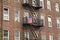 Puerto Rican flag hangs of the fire escape of a brick tenement building