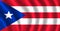 PUERTO RICAN WELDER WITH BACKGROUND OF HIS FLAG WAVES