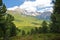 Puez Odle mountain range viewed from a hiking path leading to Mount Pic above Raiser Pass with colorful flowers and trees in the