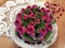 Puff pancakes collected in roses, decorated with cranberries, decorated on a platter, close-up, top view