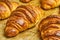 Puff pastry croissants with chocolate on baking sheet. Homemade cooking. Concept of international cuisine.