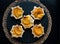 Puff pastry with custard, peach on round black slate