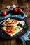 Puff pastry pies with egg, bacon, mushrooms and tomato