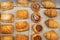 Puff pastry rolls. fresh sweet baking on papyrine. Several kinds of crispy pies lie in rows on a baking sheet on the counter. Top