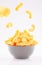 Puffed corn chips in gray bowl on white background