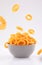 Puffed corn rings chips in  gray bowl on white background